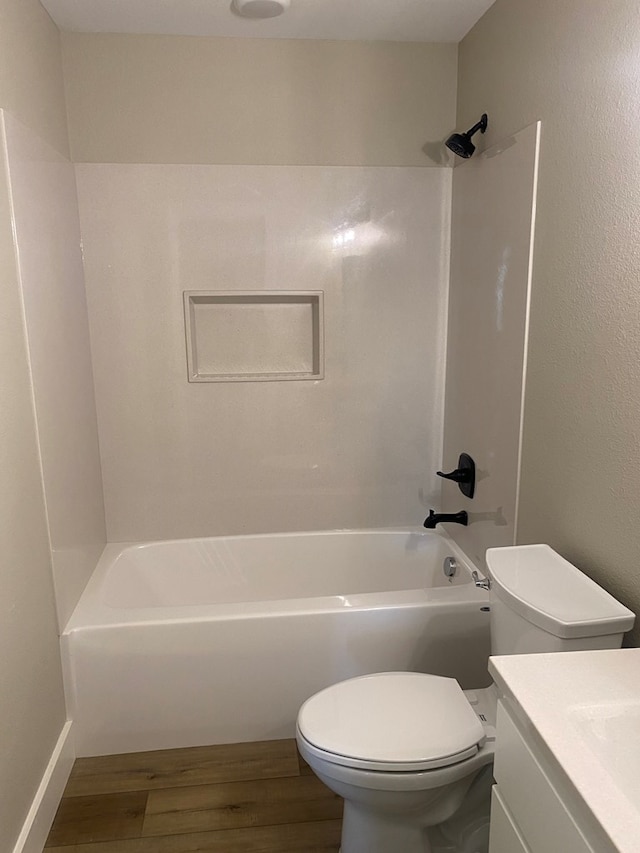 full bathroom with hardwood / wood-style flooring, shower / bathtub combination, vanity, and toilet