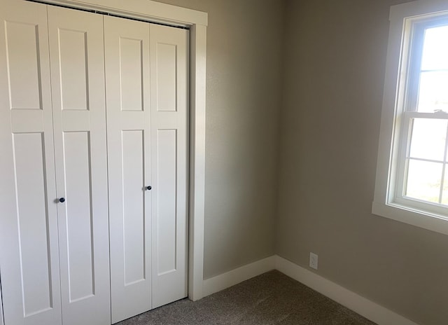 unfurnished bedroom with carpet and a closet