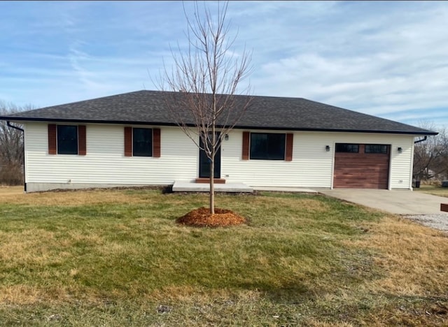 single story home featuring a garage and a front lawn