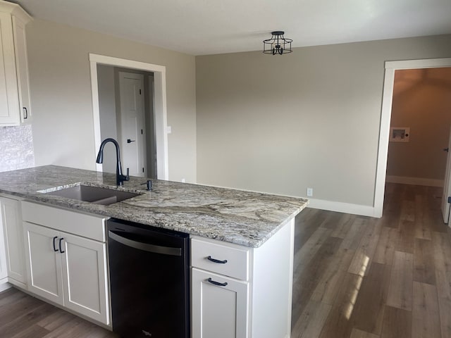 kitchen with black dishwasher, sink, white cabinets, light stone counters, and kitchen peninsula