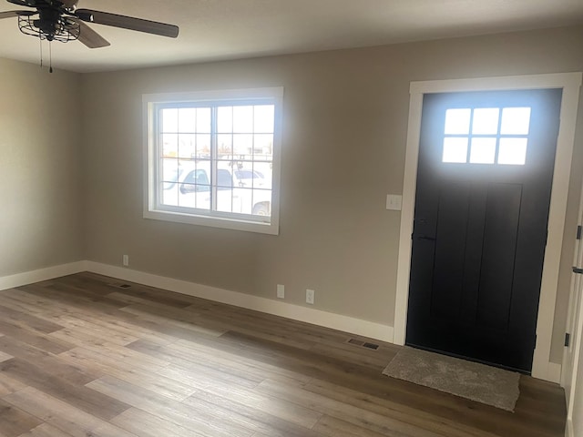 foyer with ceiling fan and wood-type flooring