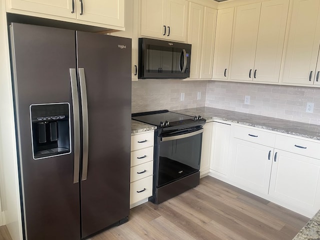 kitchen featuring electric stove, light stone counters, tasteful backsplash, stainless steel fridge with ice dispenser, and light wood-type flooring