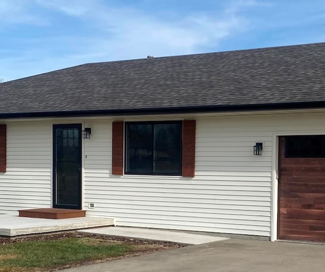 doorway to property with a garage