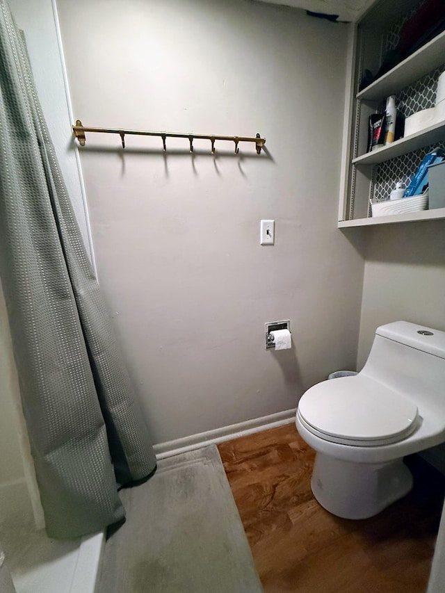 1205 Randolph St, Kirksville, MO 63501 - bathroom featuring wood finished floors and a shower with shower curtain