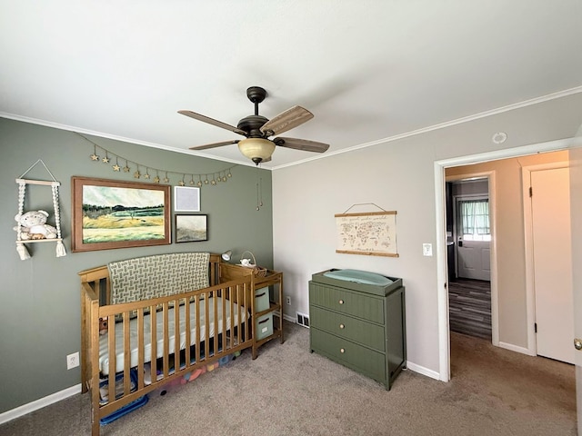 1205 Randolph St, Kirksville, MO 63501 - carpeted bedroom with crown molding, a crib, and a ceiling fan