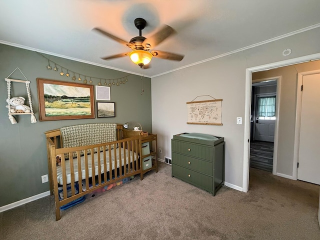 1205 Randolph St, Kirksville, MO 63501 - carpeted bedroom featuring crown molding, a crib, and a ceiling fan
