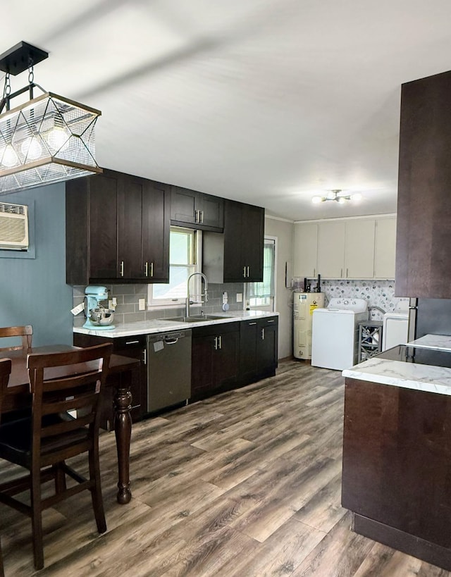 1205 Randolph St, Kirksville, MO 63501 - kitchen with stainless steel dishwasher, washer and dryer, light countertops, water heater, and tasteful backsplash