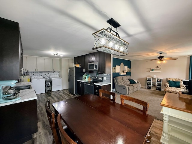 1205 Randolph St, Kirksville, MO 63501 - dining area with separate washer and dryer, ceiling fan, and dark wood finished floors
