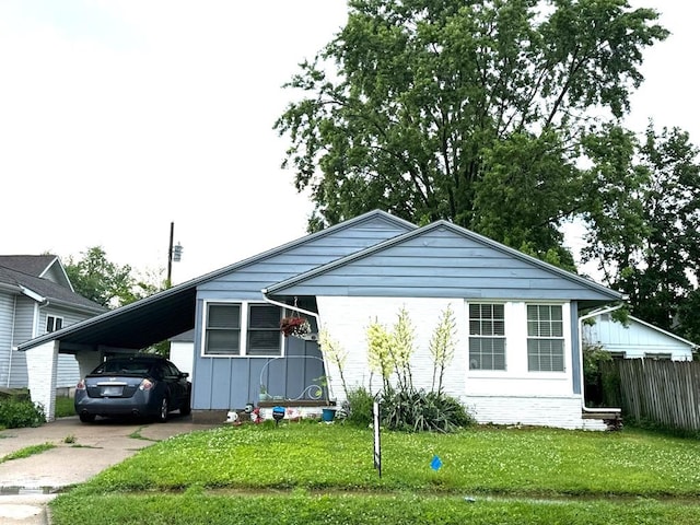 1205 Randolph St, Kirksville, MO 63501 - view of front facade featuring concrete driveway, a carport, and board and batten siding