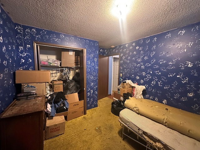 interior space with a textured ceiling and wallpapered walls