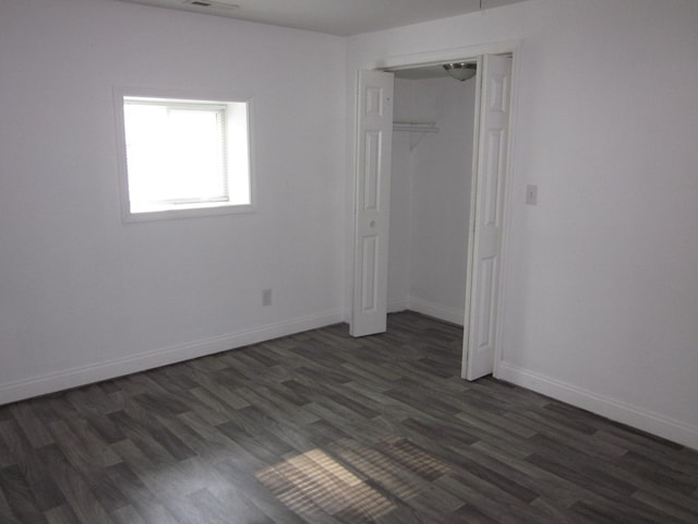 unfurnished room featuring dark hardwood / wood-style flooring