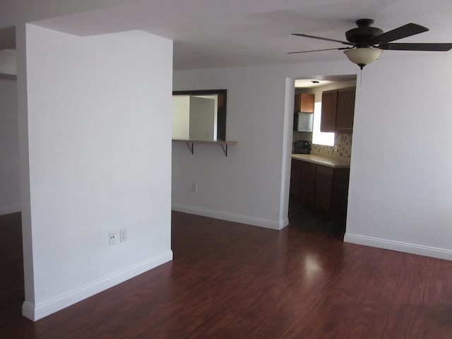 spare room featuring dark hardwood / wood-style floors and ceiling fan