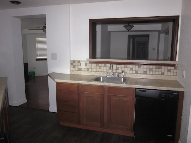 kitchen featuring tasteful backsplash, ceiling fan, dark wood-type flooring, sink, and dishwasher