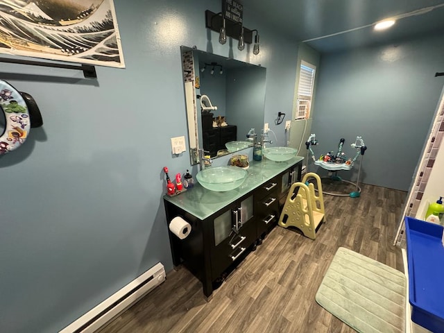 104 Conkle, Brashear, MO 63533 - bathroom with a baseboard radiator, wood finished floors, and double vanity