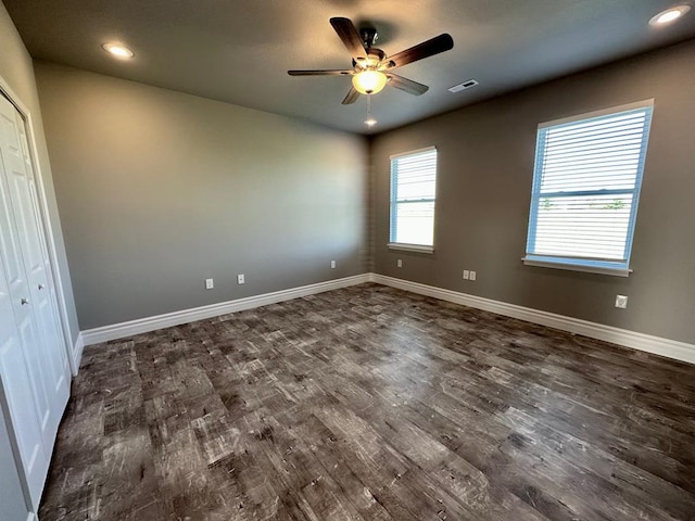 interior space with ceiling fan and dark wood-type flooring