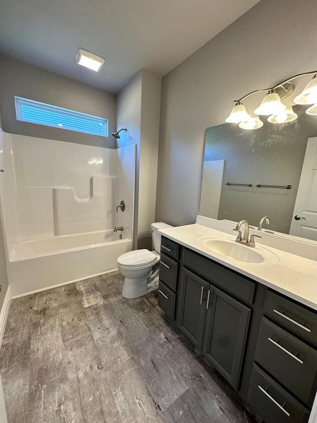 full bathroom featuring hardwood / wood-style flooring, vanity, toilet, and shower / bathing tub combination