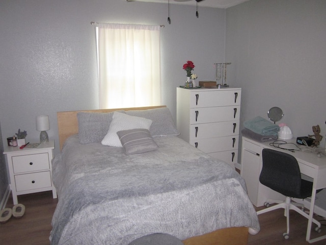 bedroom with dark hardwood / wood-style flooring