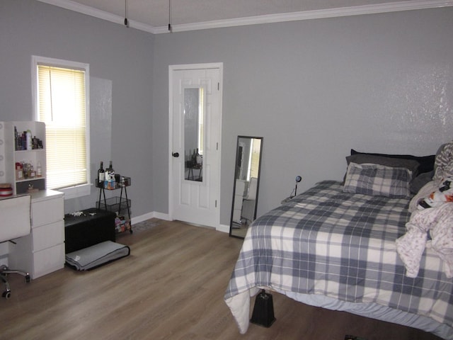 bedroom with light hardwood / wood-style flooring and crown molding