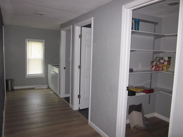 corridor featuring dark hardwood / wood-style floors and washer / clothes dryer