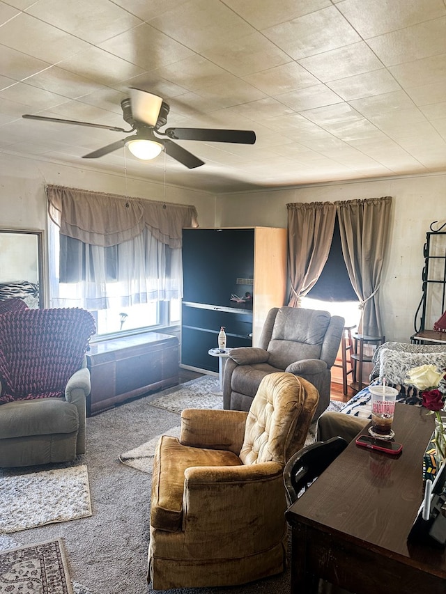 carpeted living room with ceiling fan