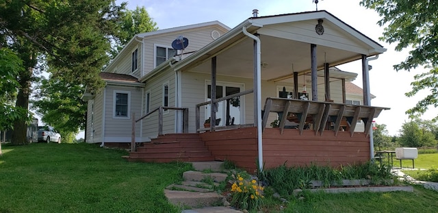 rear view of property with a lawn