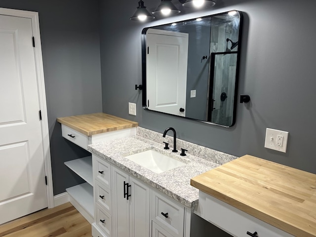 1216 N Franklin St, Kirksville, MO 63501 - bathroom featuring wood finished floors and vanity