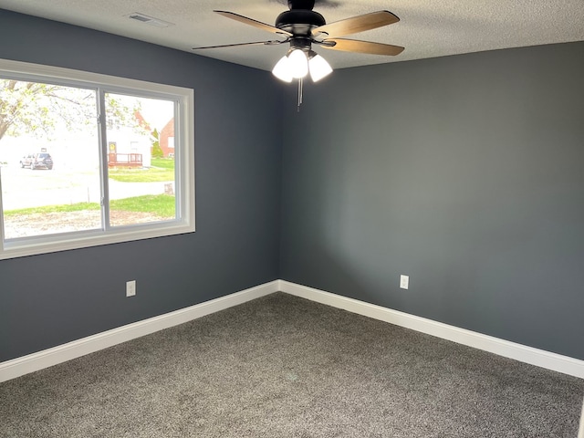1216 N Franklin St, Kirksville, MO 63501 - carpeted empty room featuring visible vents, ceiling fan, baseboards, and a textured ceiling