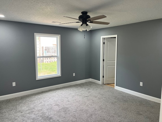 1216 N Franklin St, Kirksville, MO 63501 - empty room featuring a textured ceiling, carpet flooring, and a ceiling fan