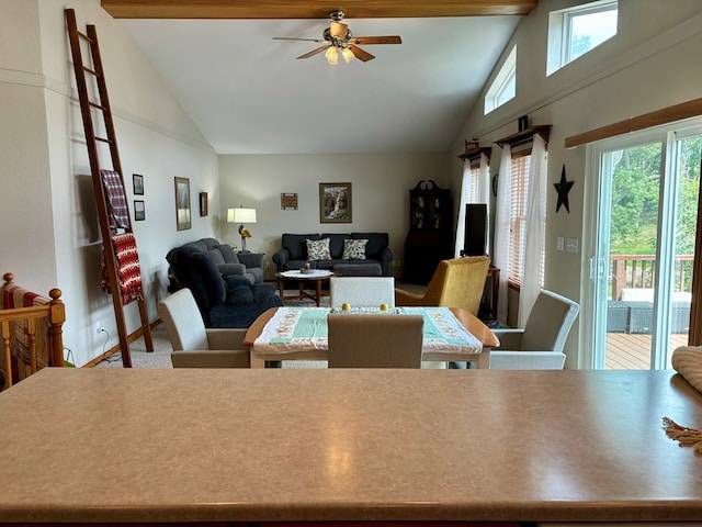 carpeted dining area with ceiling fan and vaulted ceiling