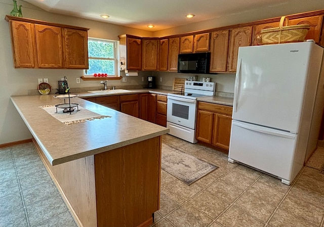 kitchen featuring kitchen peninsula, sink, and white appliances