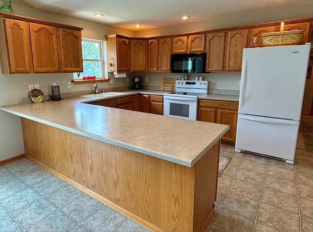 kitchen featuring kitchen peninsula, white appliances, and sink