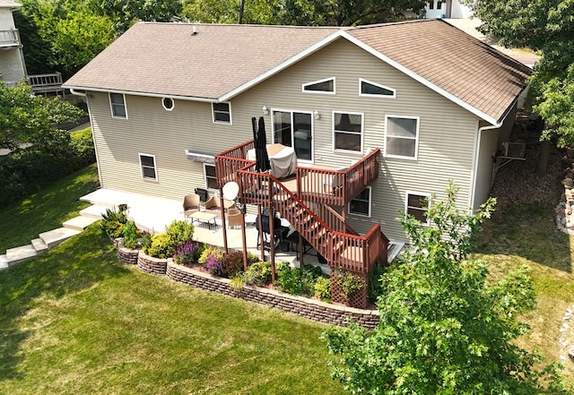 rear view of house featuring a lawn, a patio area, and a deck