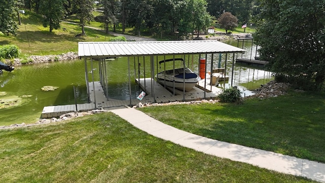 view of dock with a yard and a water view