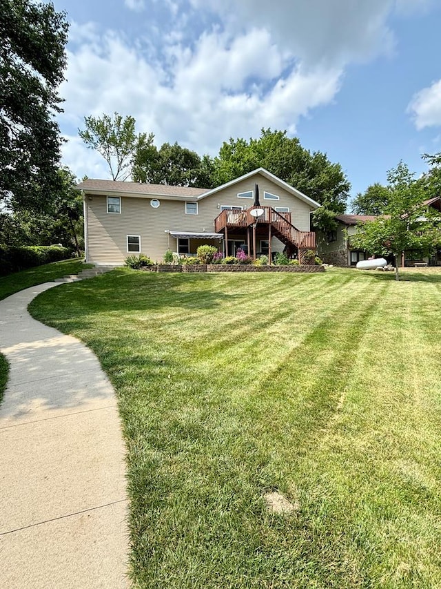 view of front of home featuring a wooden deck and a front lawn