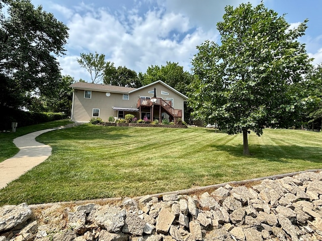 view of front of house featuring a front lawn and a wooden deck