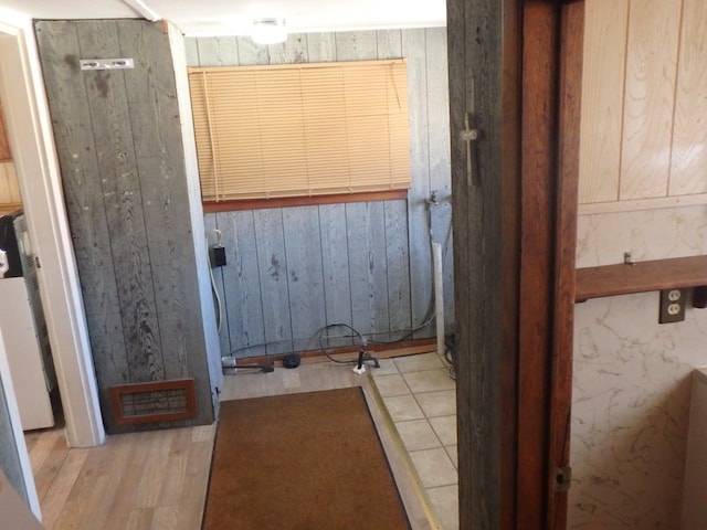 bathroom featuring wood walls and wood-type flooring