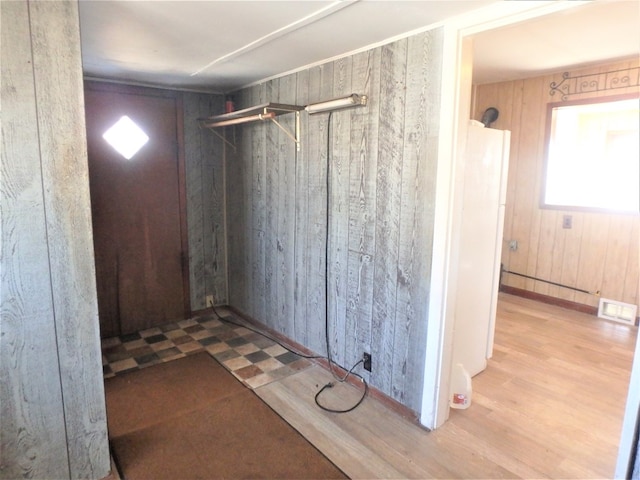 interior space with walk in shower, wood walls, and hardwood / wood-style flooring