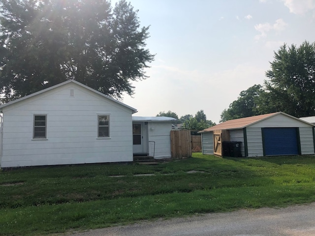 exterior space with a storage shed and a front lawn