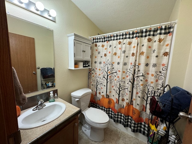 bathroom featuring tile patterned floors, a textured ceiling, vanity, vaulted ceiling, and toilet