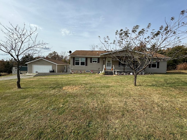 view of front of property with a porch, a garage, an outbuilding, and a front yard