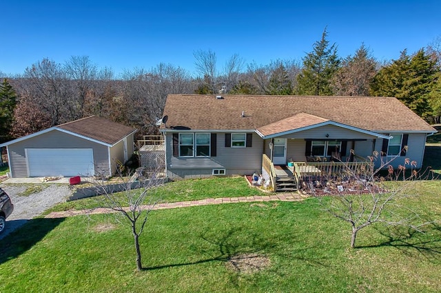 back of property with an outbuilding, a garage, a lawn, and covered porch