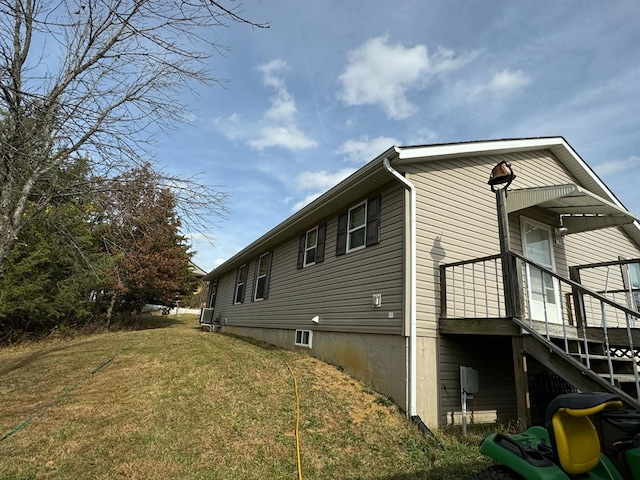 view of side of home featuring a yard