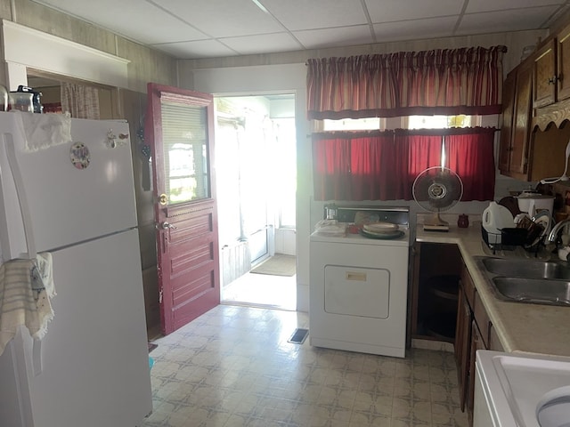 110 Van Buren St, Browning, MO 64630 - kitchen featuring freestanding refrigerator, washer / clothes dryer, light floors, light countertops, and a paneled ceiling