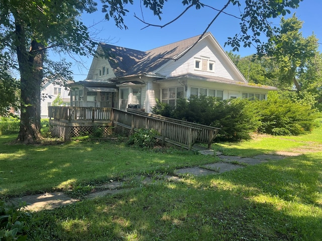 110 Van Buren St, Browning, MO 64630 - view of home's exterior featuring a deck and a lawn