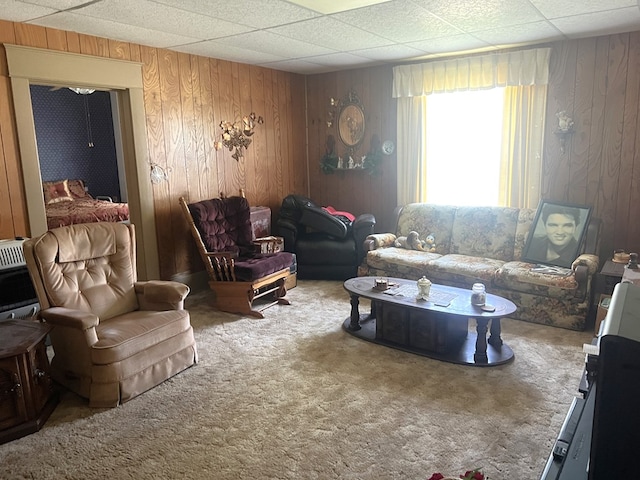 110 Van Buren St, Browning, MO 64630 - living room featuring carpet flooring, wooden walls, heating unit, and a drop ceiling