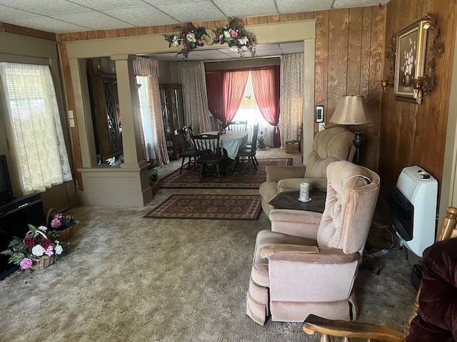110 Van Buren St, Browning, MO 64630 - carpeted living room featuring ornate columns, wooden walls, heating unit, and a paneled ceiling