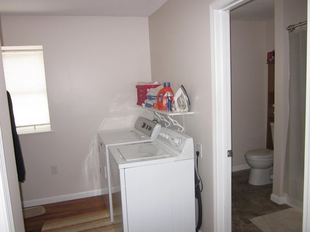 laundry room with washer and dryer and wood-type flooring