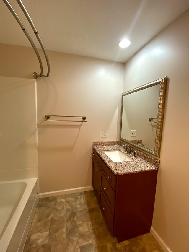 bathroom with vanity and bathtub / shower combination