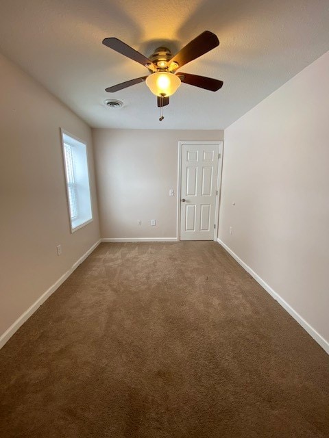 empty room with carpet floors and ceiling fan