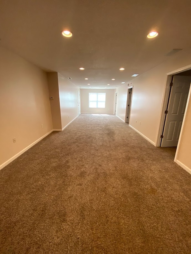 spare room with dark carpet